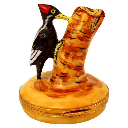 Artisan porcelain Limoges box featuring a detailed woodpecker perched on a tree trunk design