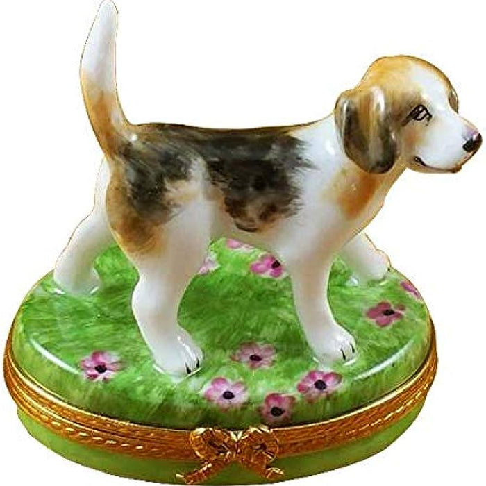 French porcelain sculptures of a dog standing on a green floral decorated base with gold trim