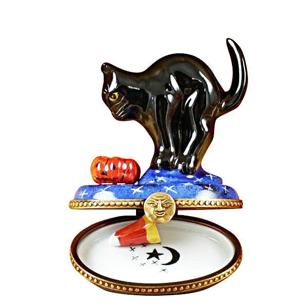 Limoges porcelain interior design ideas featuring a decorative trinket box with a black cat and pumpkin on a blue base