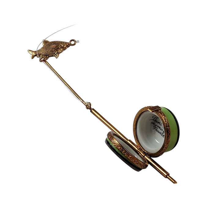 Open green Limoges box shaped like a fishing rod with detailed gold fish ornament showing Limoges box shapes and sizes