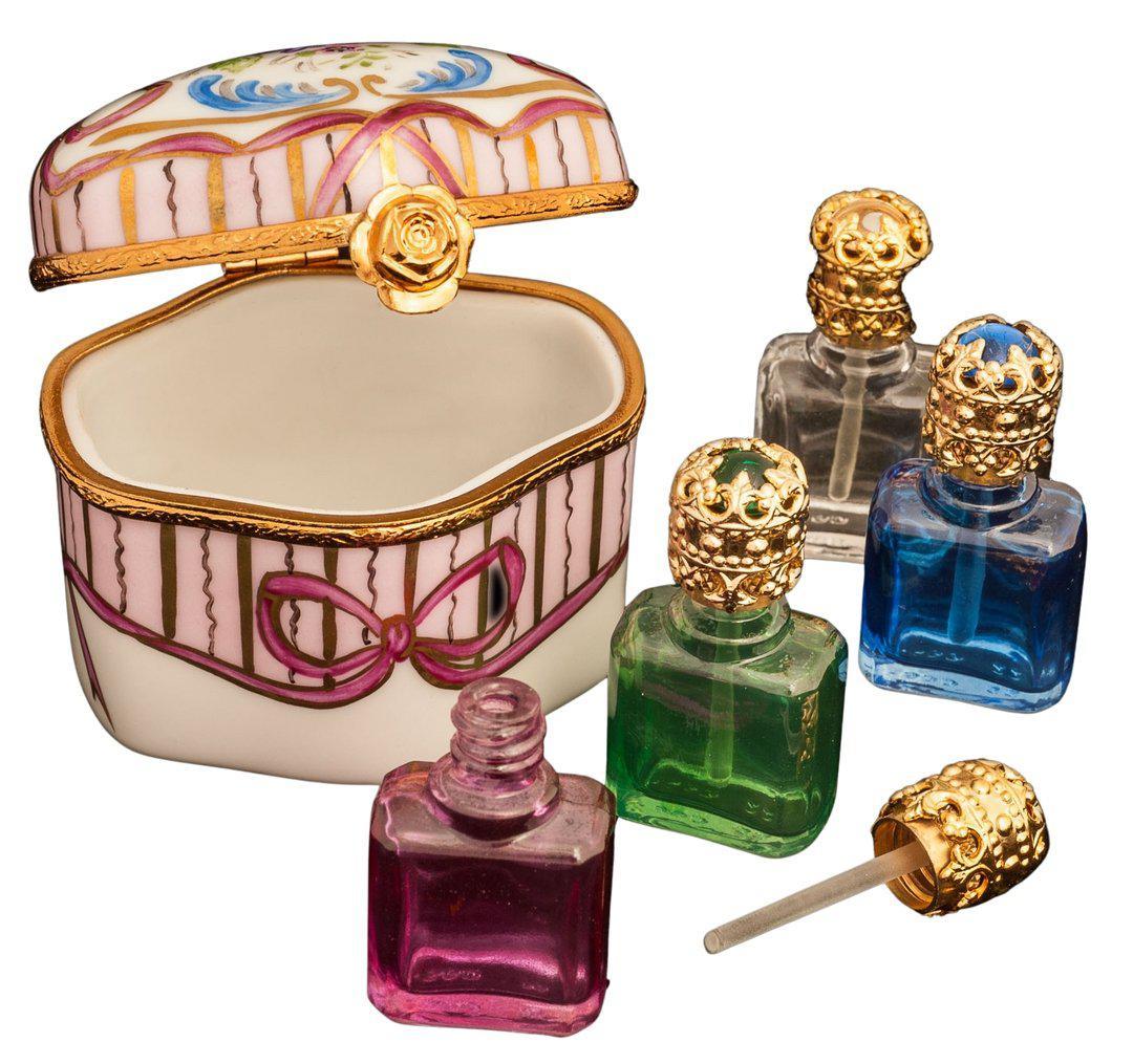 Elegant porcelain for home decor featuring a decorative Limoges trinket box and ornate small glass perfume bottles