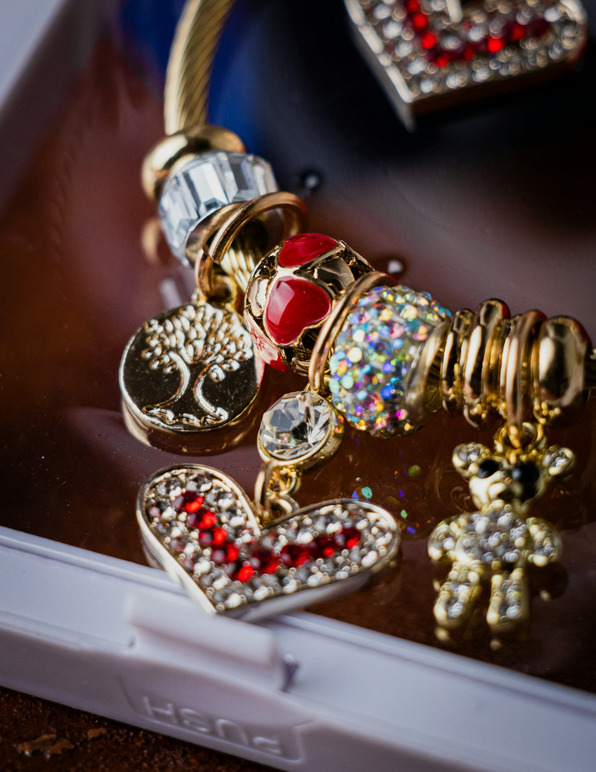 a close up of a cell phone with a bunch of charms on it