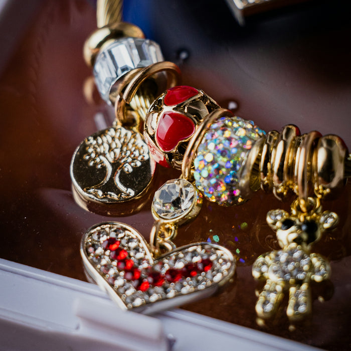 a close up of a cell phone with a bunch of charms on it