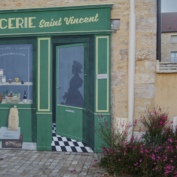 a building with a green door and a checkered floor