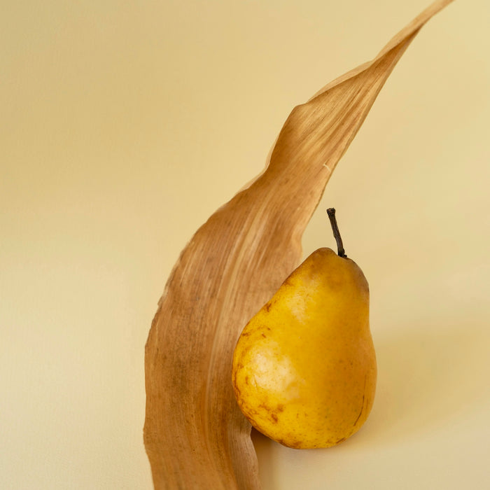 a piece of wood with a pear on it