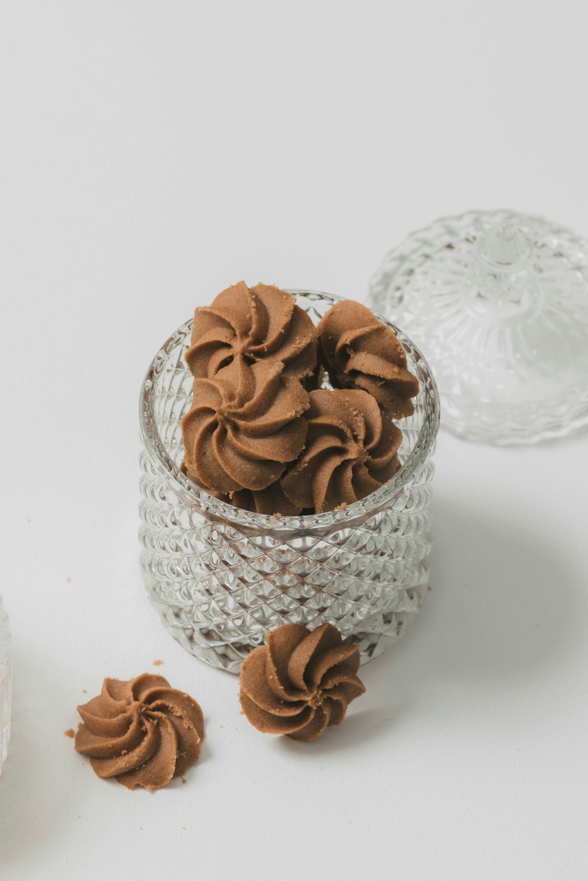 A small glass bowl filled with chocolate frosting