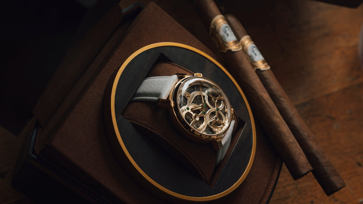 A luxury watch and cigars on display.