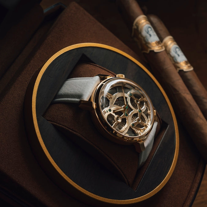 A luxury watch and cigars on display.