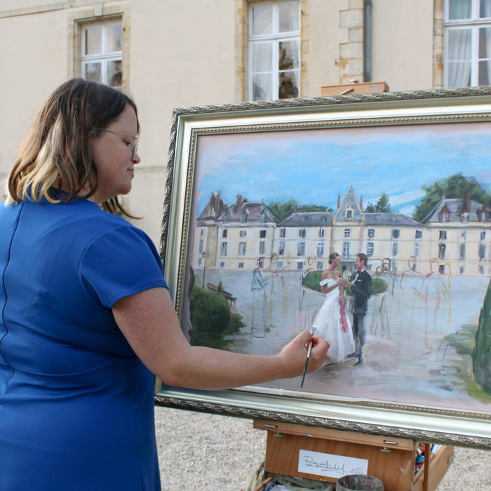 Artist paints a wedding scene at a chateau