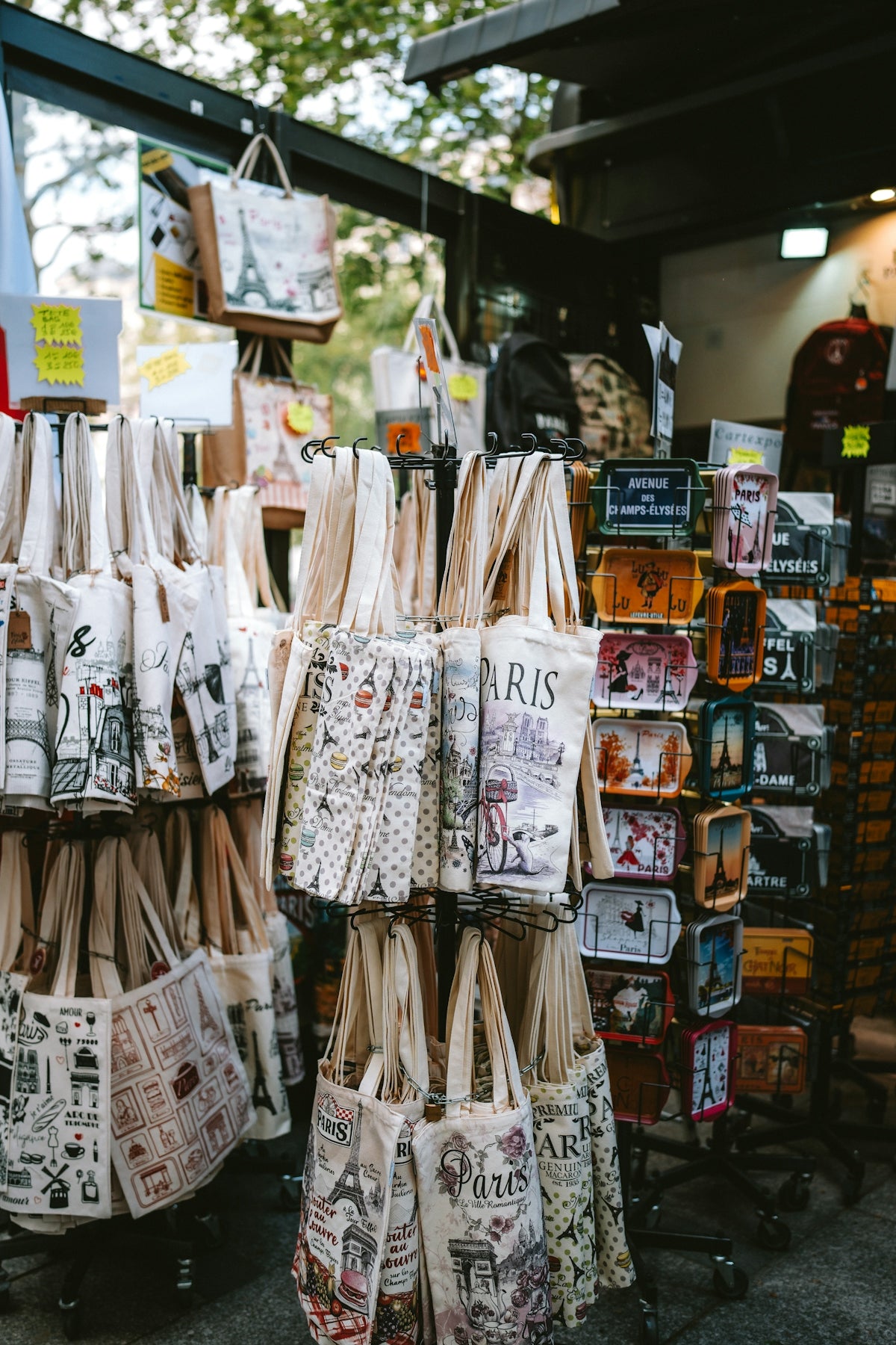 Souvenir tote bags and tins displayed at a market stall