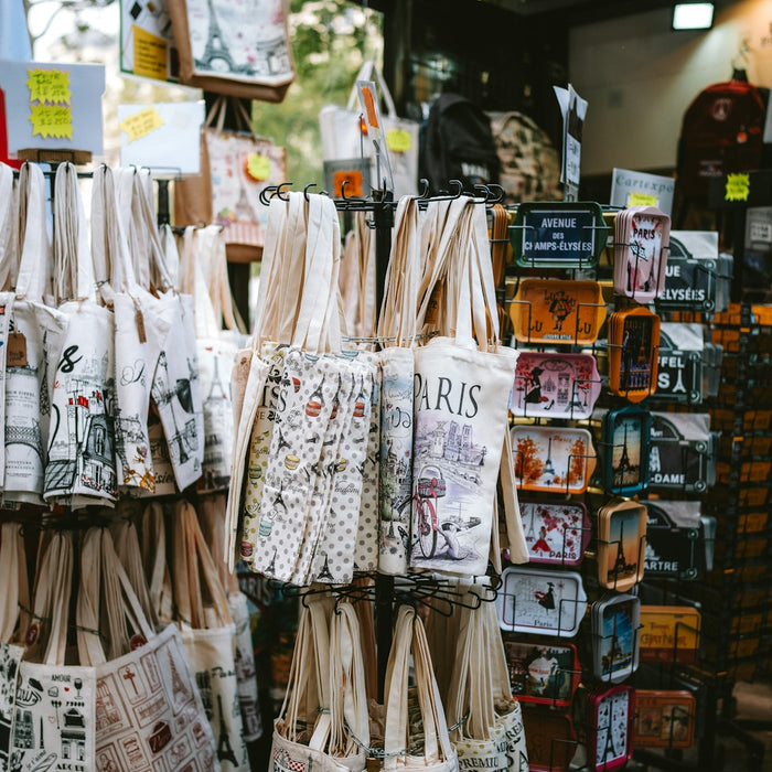 Souvenir tote bags and tins displayed at a market stall