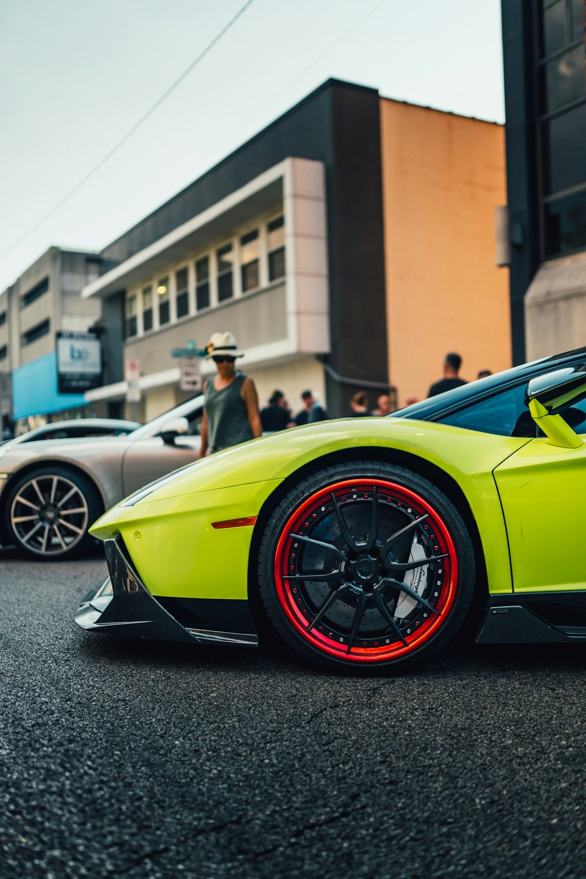 Lime green sports car with red rims on street