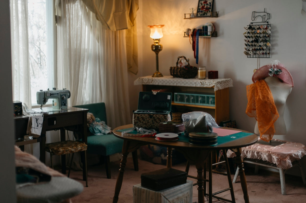 A sewing room with a vintage sewing machine and supplies.