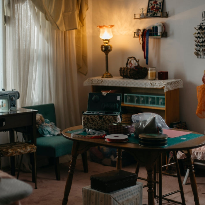 A sewing room with a vintage sewing machine and supplies.