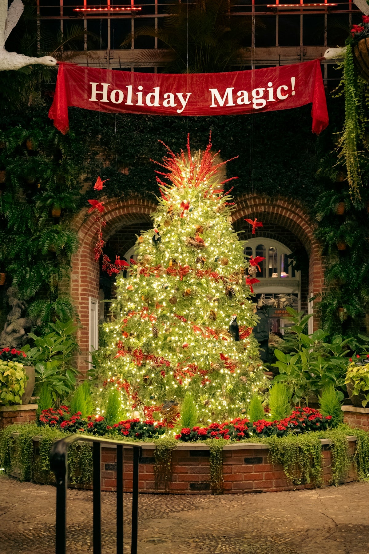 Decorated christmas tree with holiday magic banner.