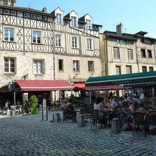 Outdoor cafes and historic buildings highlighting reasons to visit Limoges France with charming architecture