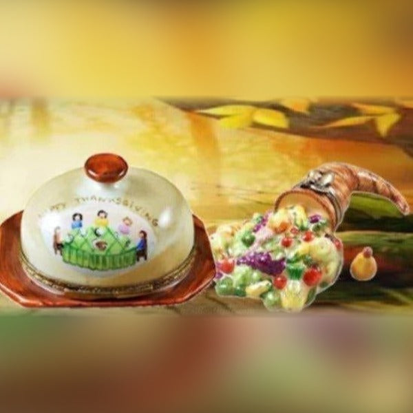 Delicately painted autumn Limoges boxes featuring a covered dish and a cornucopia with colorful fruits