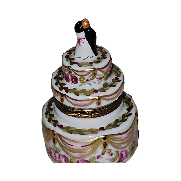 Every brushstroke by hand on the Couple on Wedding Cake Gold Pink Ribbons Limoges box from France