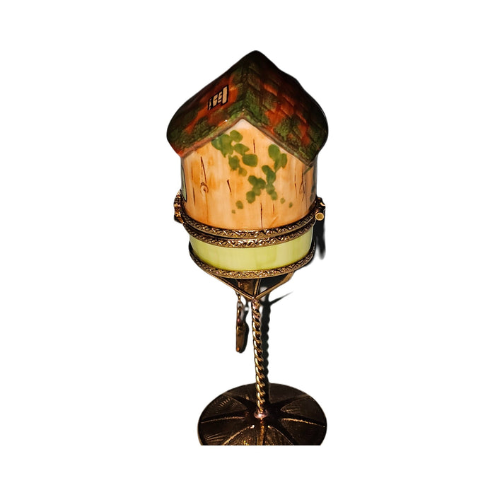 The painter's artistry shows on this Orange Birdhouse on Stand Limoges box