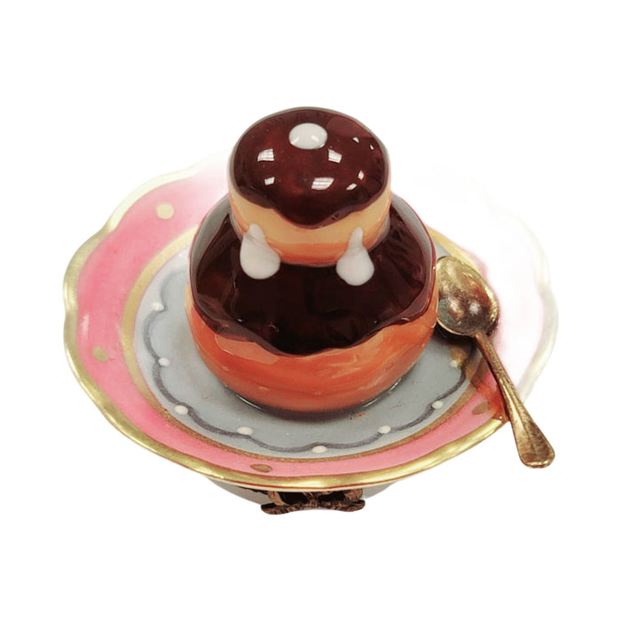 Limoges Boutique presents the Cream Puff on Plate, a genuine Limoges box painted by hand in France