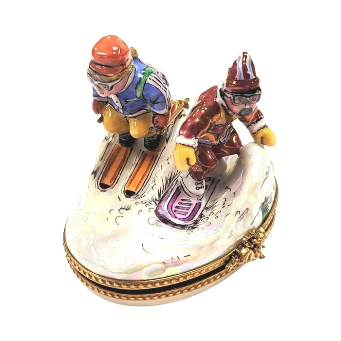 Side view of the crouched skiers on the oval Limoges box, a gift for lovers of the slopes