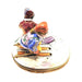 Skis and poles crossing from above on the skiers Limoges box, purple and orange details