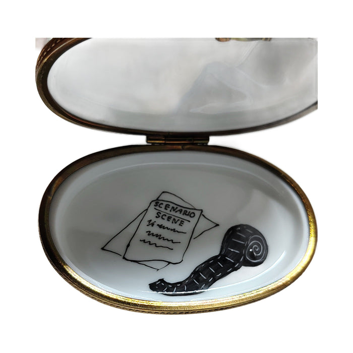 Inside the movie camera Limoges box, a painted script and film reel on the lid