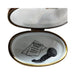 Inside the movie camera Limoges box, a painted script and film reel on the lid