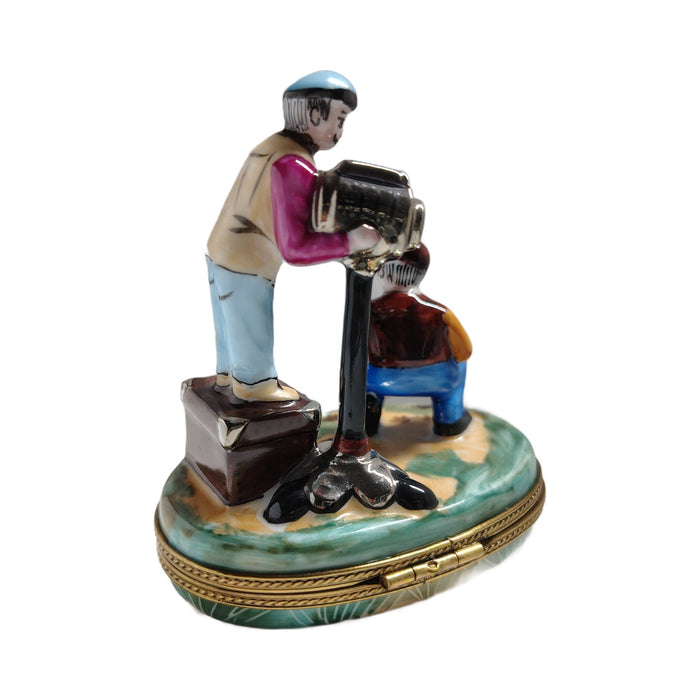 Film director and camera on a green oval base, a hand-painted Limoges box shown in the studio