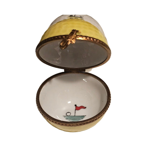 Artisan-painted Yellow Golf Ball with Flag Painted Inside Limoges box from France, a cherished collectible
