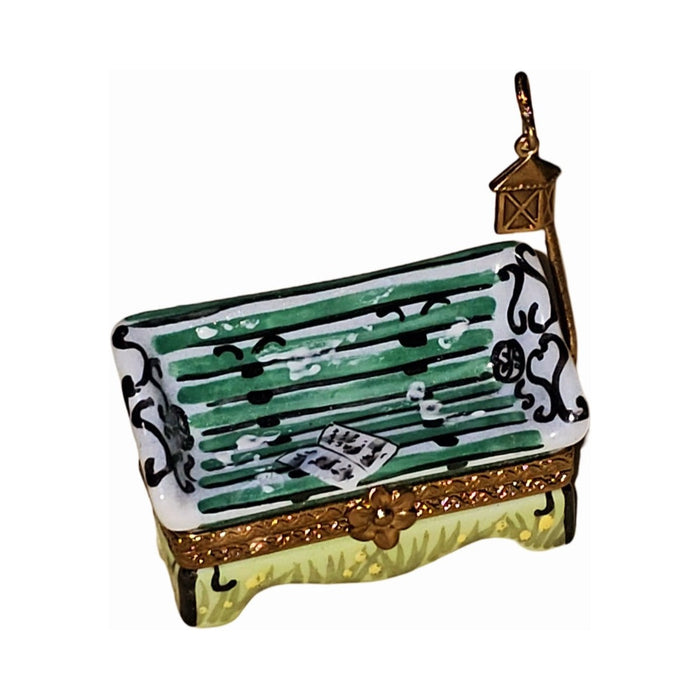 Limoges Boutique presents the Small Garden Bench Charm, a genuine Limoges box painted by hand in France